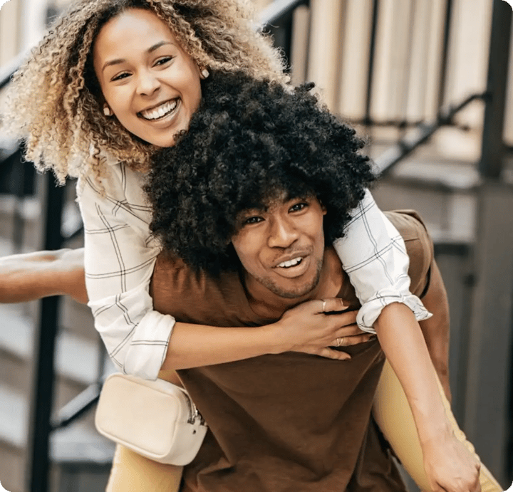 A young man giving a woman a piggyback ride on a city street, both smiling, introducing the Key Takeaway section of the report.